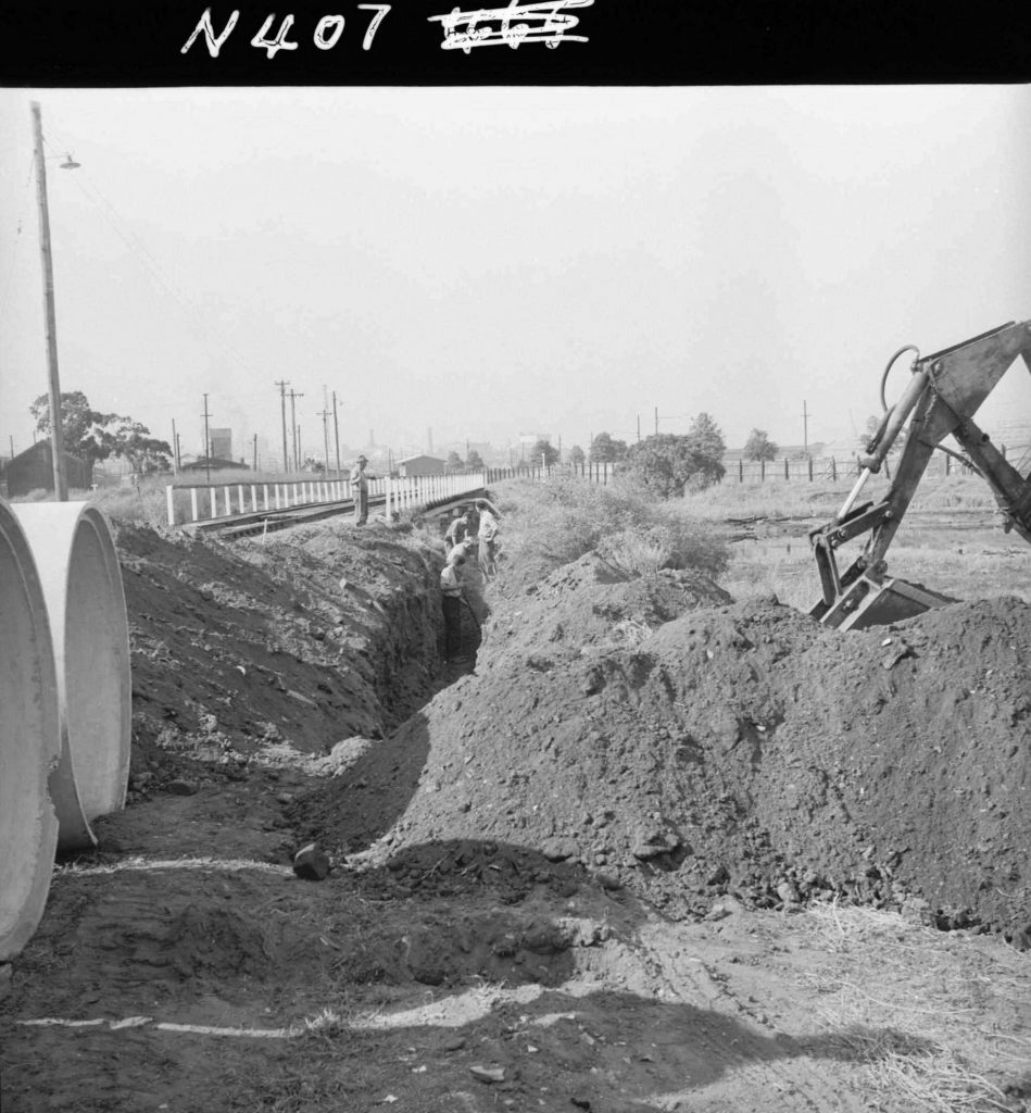 N407 Image showing installation of a drain under the railway, during construction of the Fish Market on Footscray Road