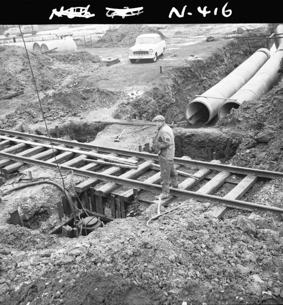 N416 Image showing the run of drain pipes and position of piles, during drain construction under the railway along Footscray Road