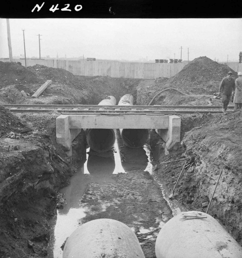 N420 Image showing a low-angle view of pipes passing under the railway culvert along Footscray Road