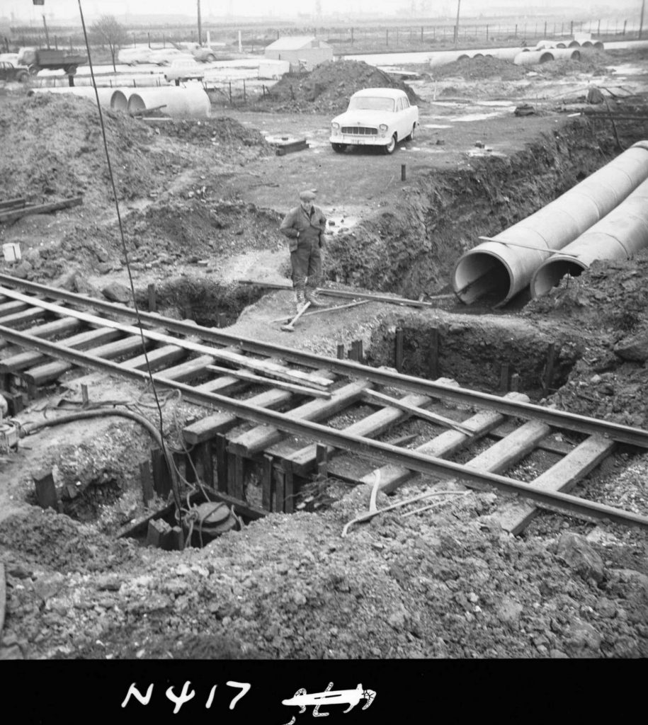 N417 Image showing the run of drain pipes and position of piles, during drain construction under the railway along Footscray Road