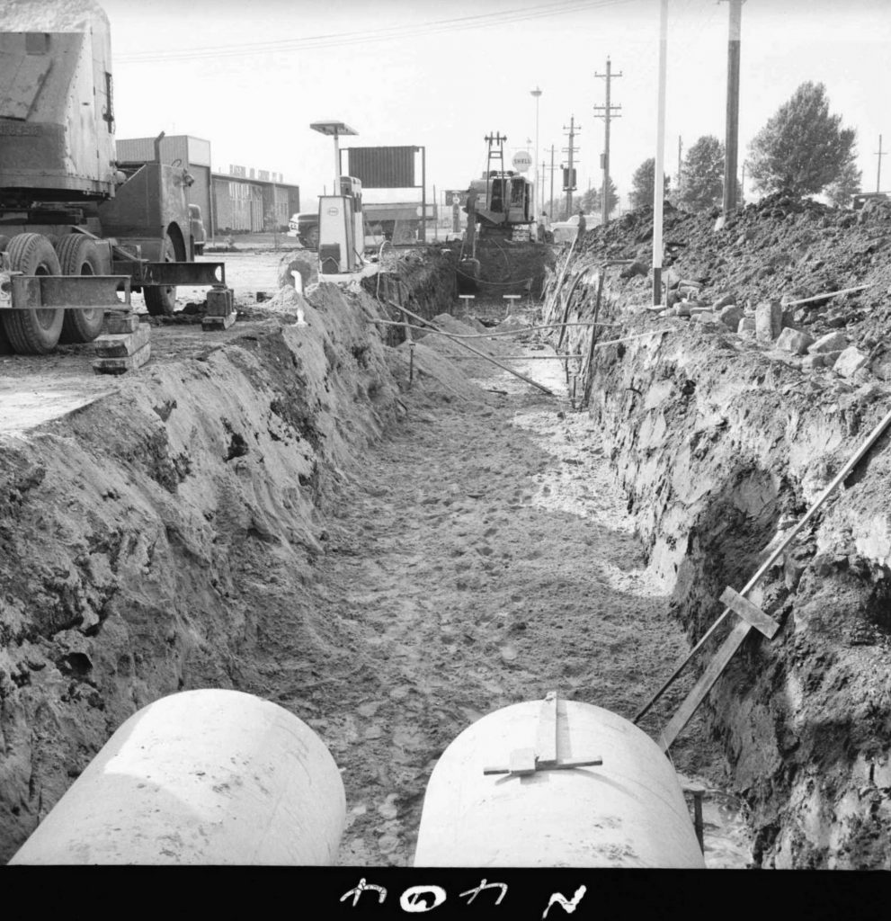 N404 Image showing a back actor excavating a trench during drain construction on Footscray Road