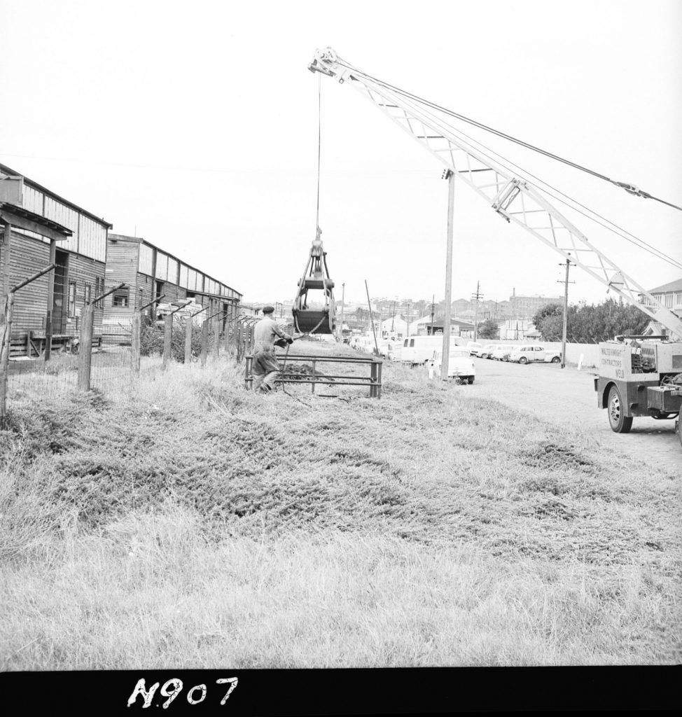 N907 Image showing man hole clearance by use of a Clamshell bucket on Dudley Street