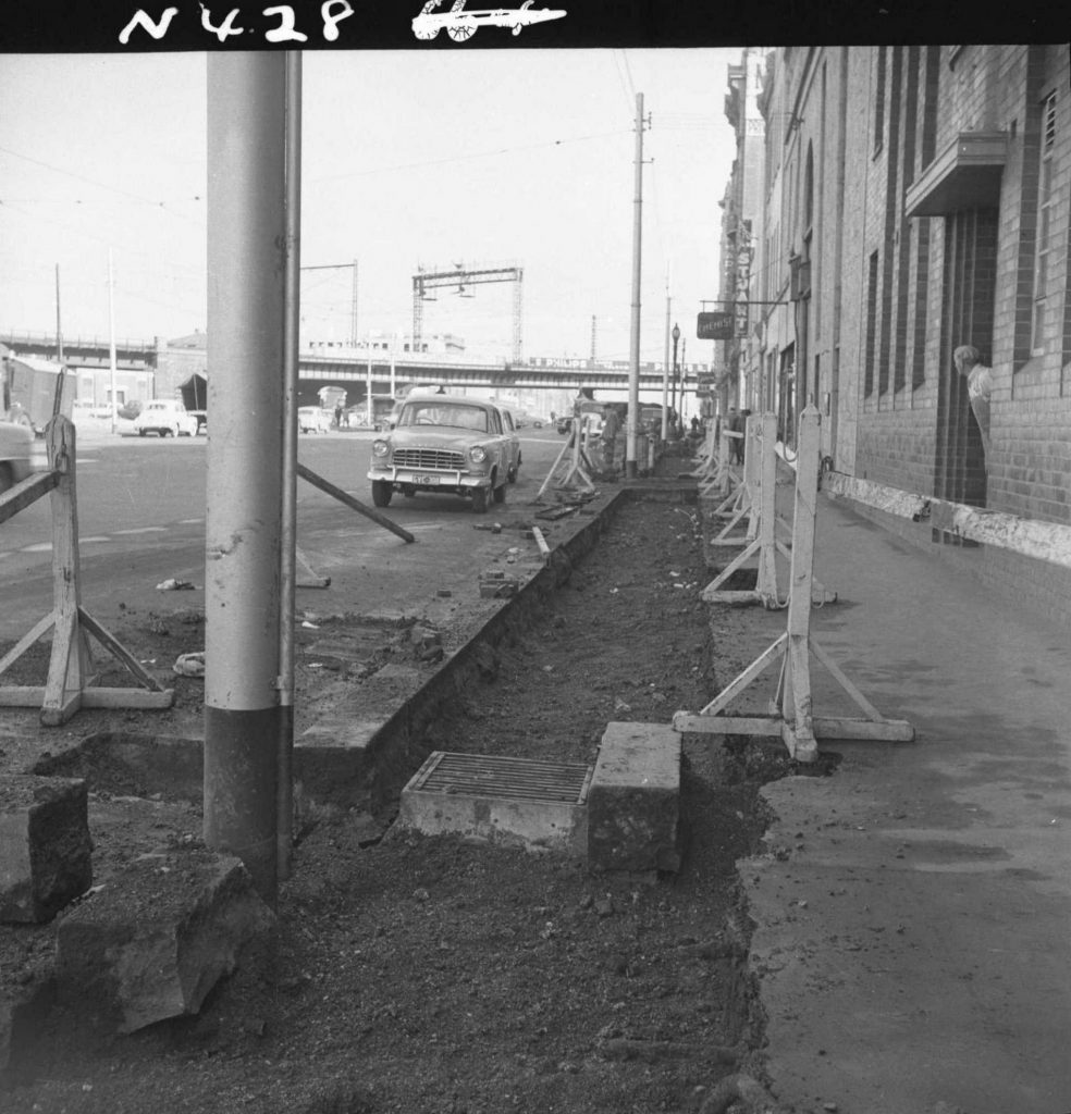 N428 Image showing the cutting back of an old kerb line during construction of the Flinders Street overpass