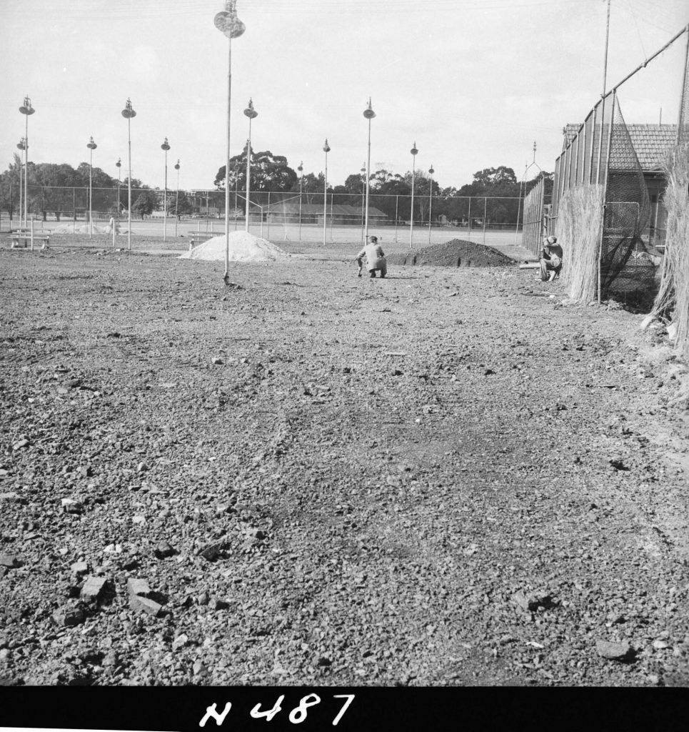 N487 Image showing an ash base laid preparatory to rolling, during construction of the Princes Park tennis courts