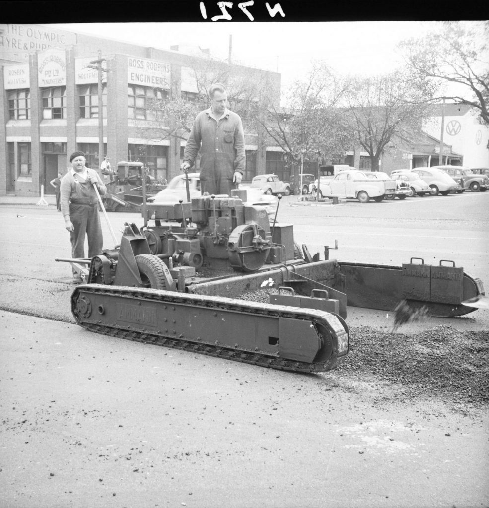 N721 Image showing an Amman footpath paver laying a finished strip of hot mix asphalt on the roadway