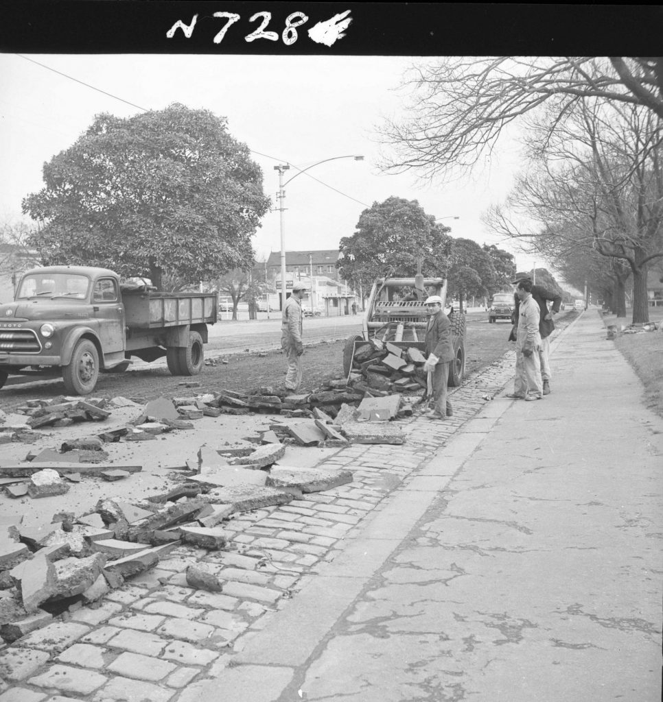 N728 Image showing the asphalt surface of a road ripped off by the ripper attachment of a front end loader