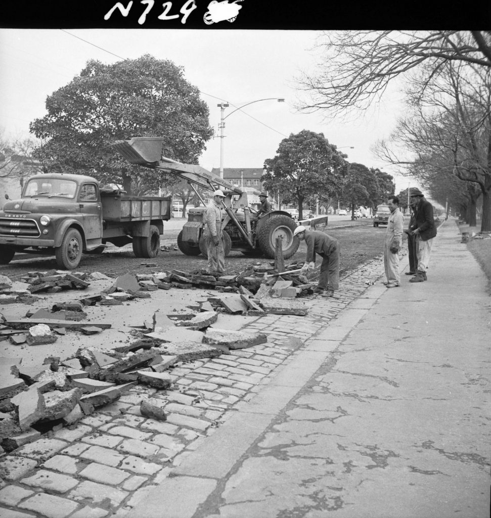 N729 Image showing the asphalt surface of a road ripped off by the ripper attachment of a front end loader