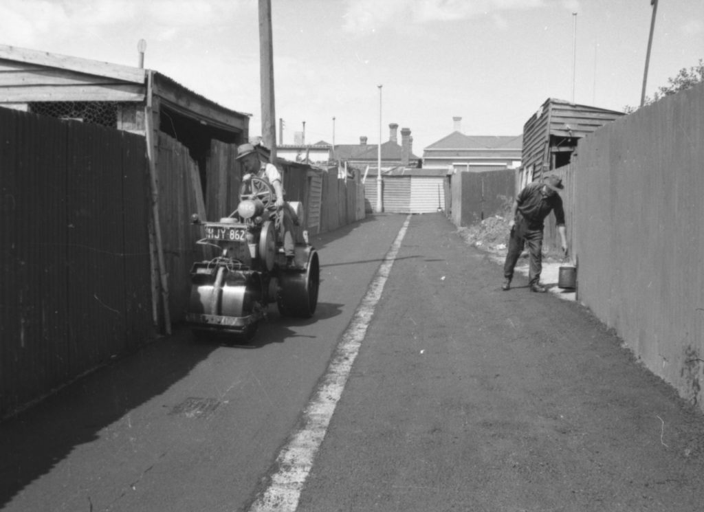 N563 Image showing spreading and rolling of hot mix asphalt in a North Melbourne lane