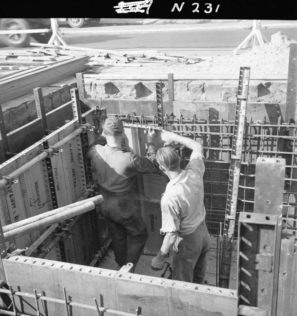 N231 Image showing workers fixing the inside wall shuttering during construction of a weighbridge on Flinders Street