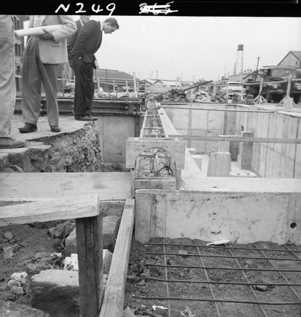 N249 Image showing the wooden template for pit kerbing during construction of a weighbridge on Flinders Street