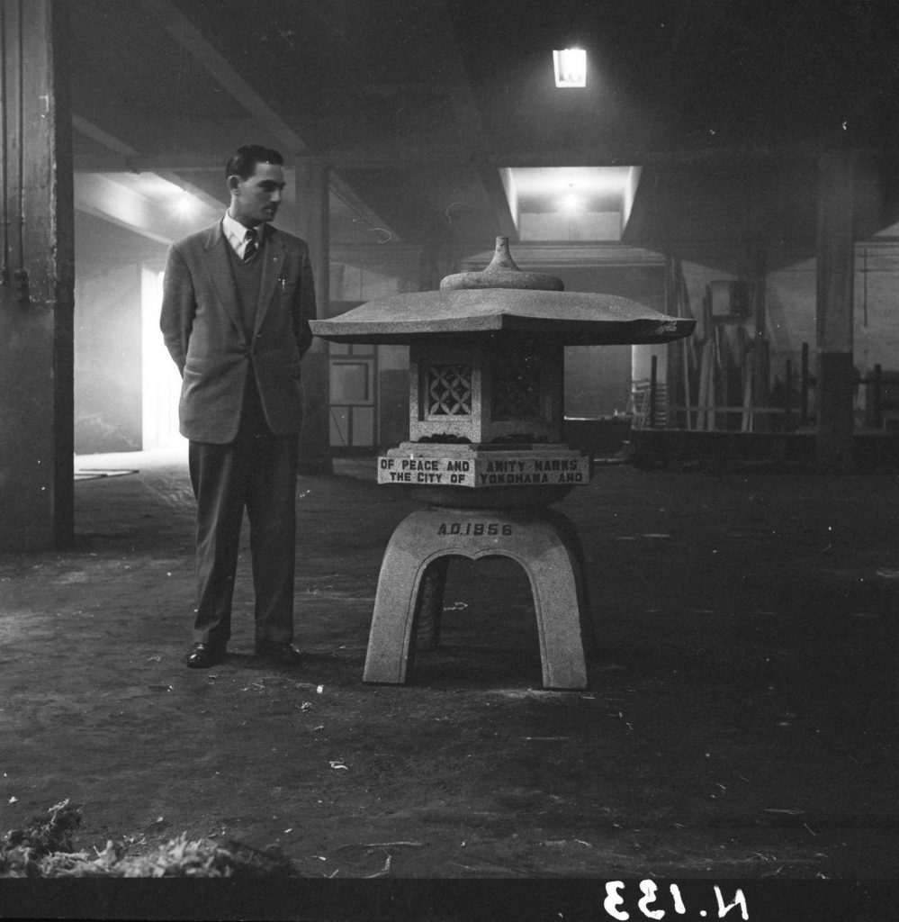 N133 Image showing a man standing next to a monument gifted from the city of Yokohama