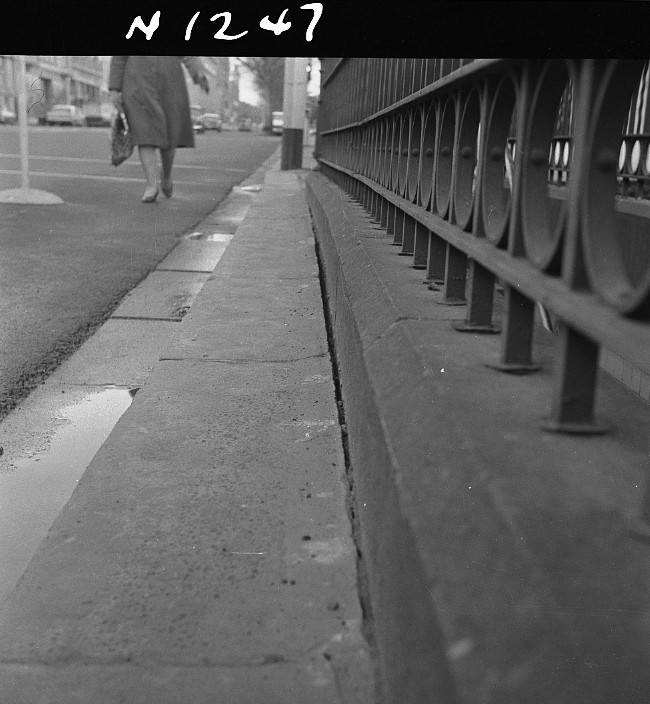 N1247 Image showing a close-up view of a gutter and public toilet entrance