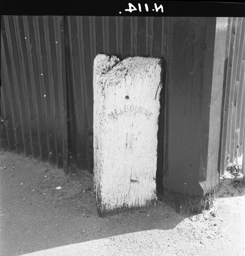 N114 Image showing a wooden milepost on the corner of Toorak Road and Domain Street