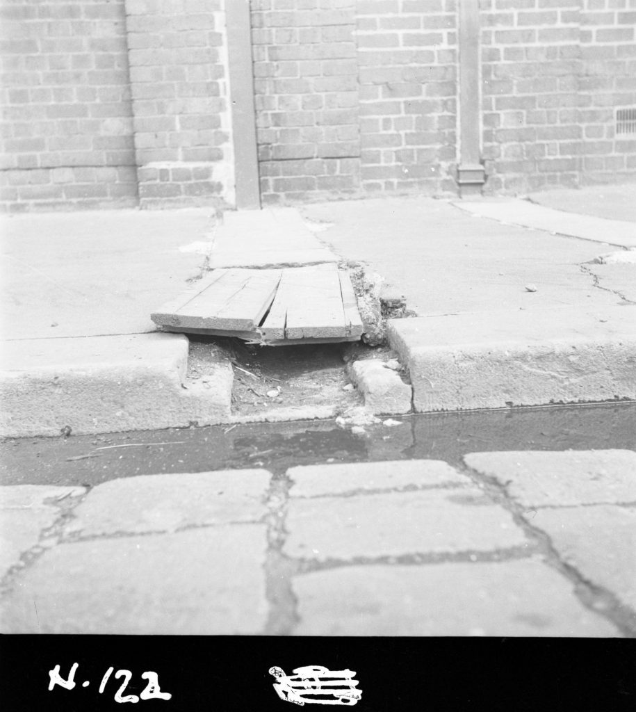 N122 Image showing a gutter and drain to the channel opposite a weighbridge