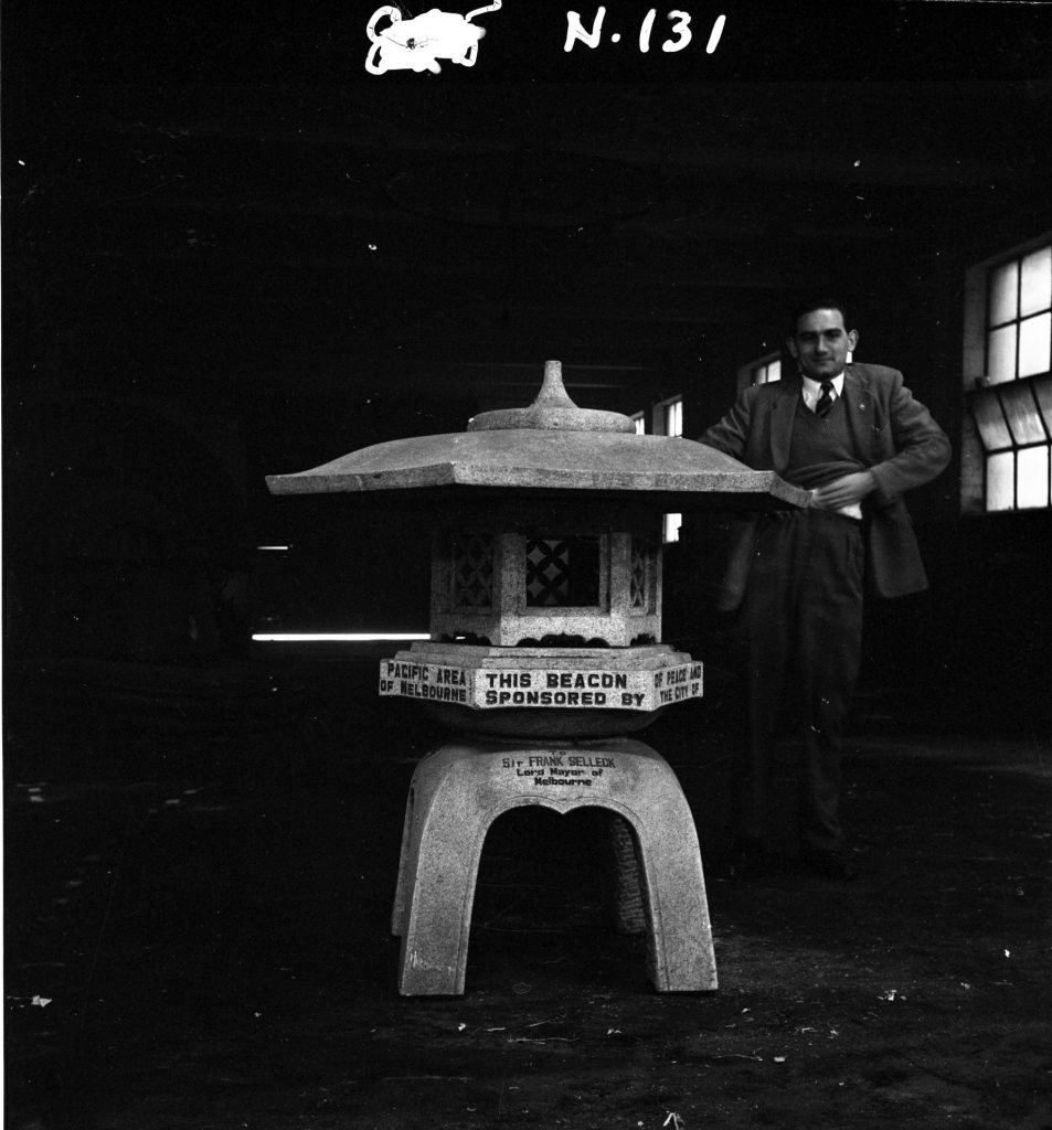 N131 Image showing a man standing next to a monument gifted from the city of Yokohama