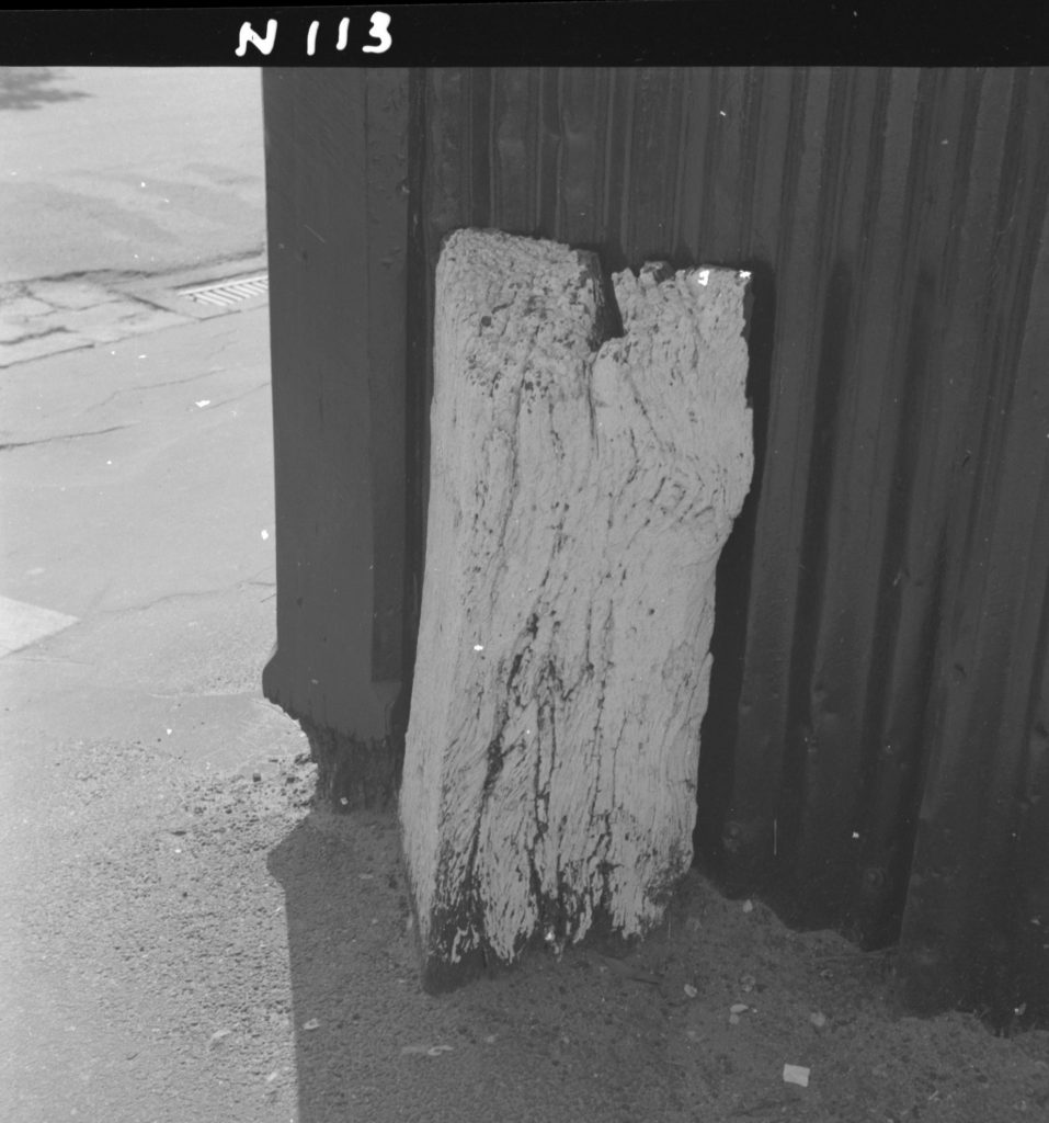 N113 Image showing a wooden milepost on the corner of Toorak Road and Domain Street