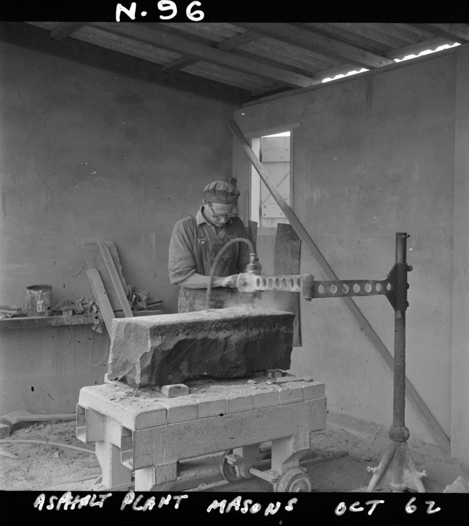 N96 Image showing a mason wearing protective goggles at a masons workshop on Green Street