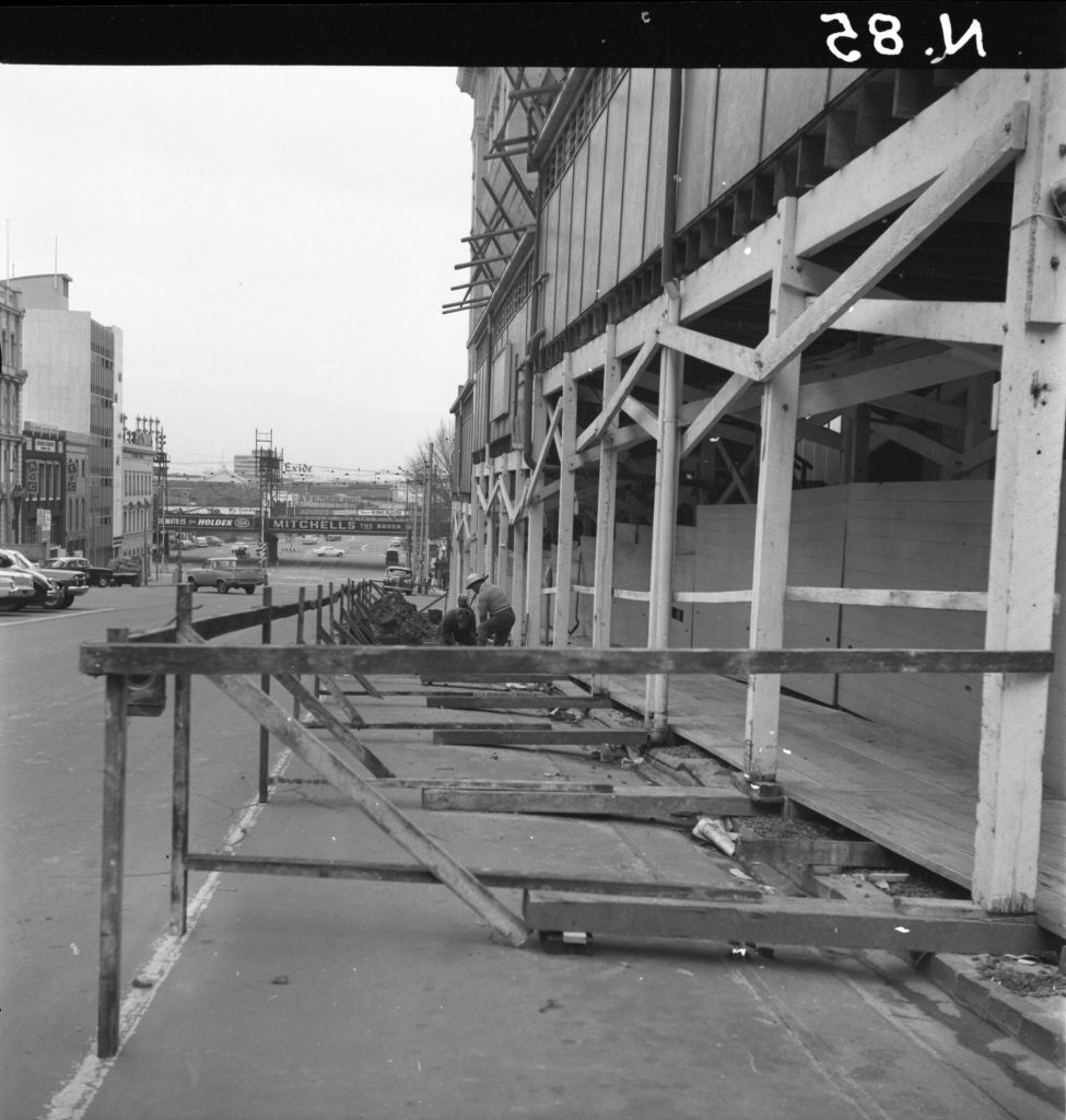 N85 Image showing hoardings and a storm drain around the Royal Globe Insurance building on Collins Street