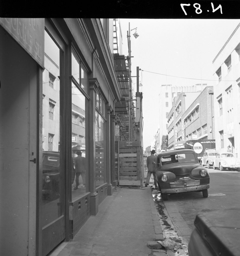 N87 Image showing E.A. Watts hoardings on Little Collins Street, between Exhibition Street and Russell Street