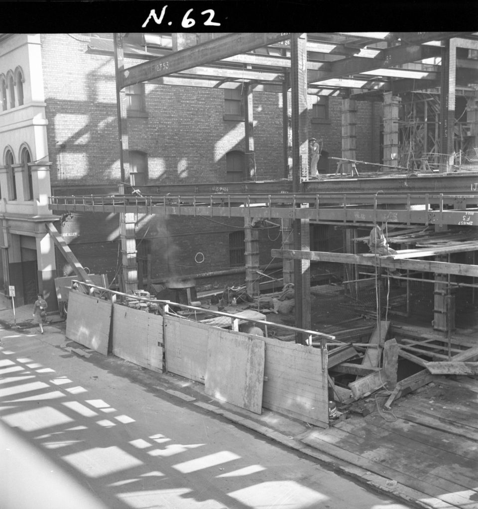 N62 Image showing hoardings with a timber crossing on Little Bourke Street