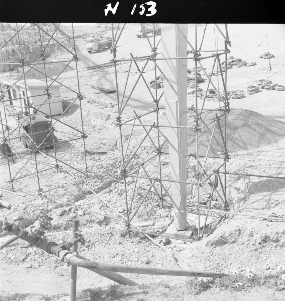 N153 Image showing the base of a pylon resting on a concrete slab foundation during construction of the Sidney Myer Music Bowl