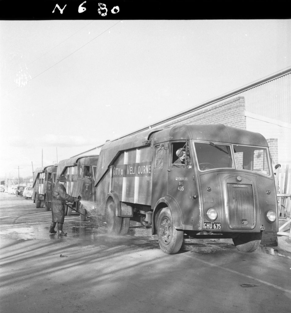 N680 Image showing a Karrier garbage truck being hosed down