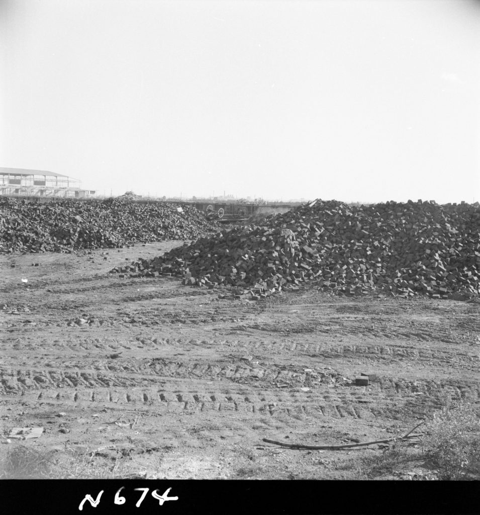 N674 Image showing a stockpile of woodblocks at the Dynon Road woodblock depot