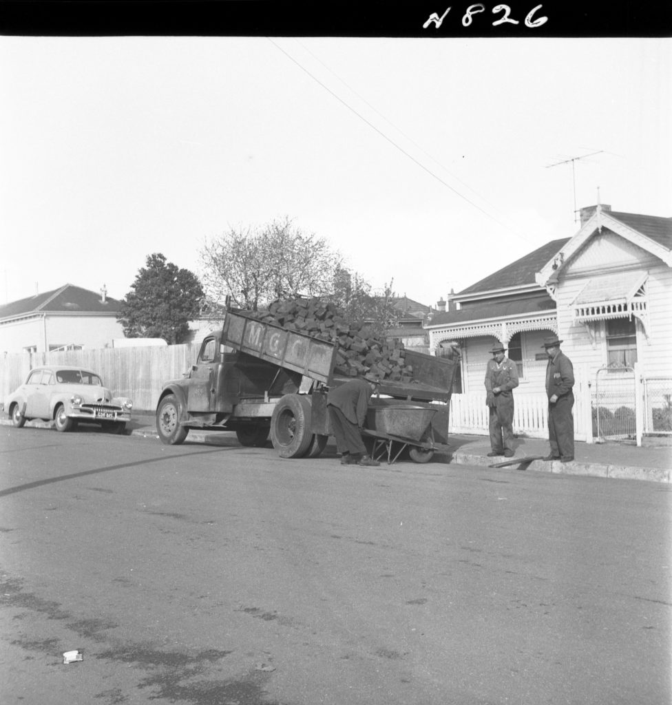 N826 Image showing woodblocks being distributed to pensioners for firewood