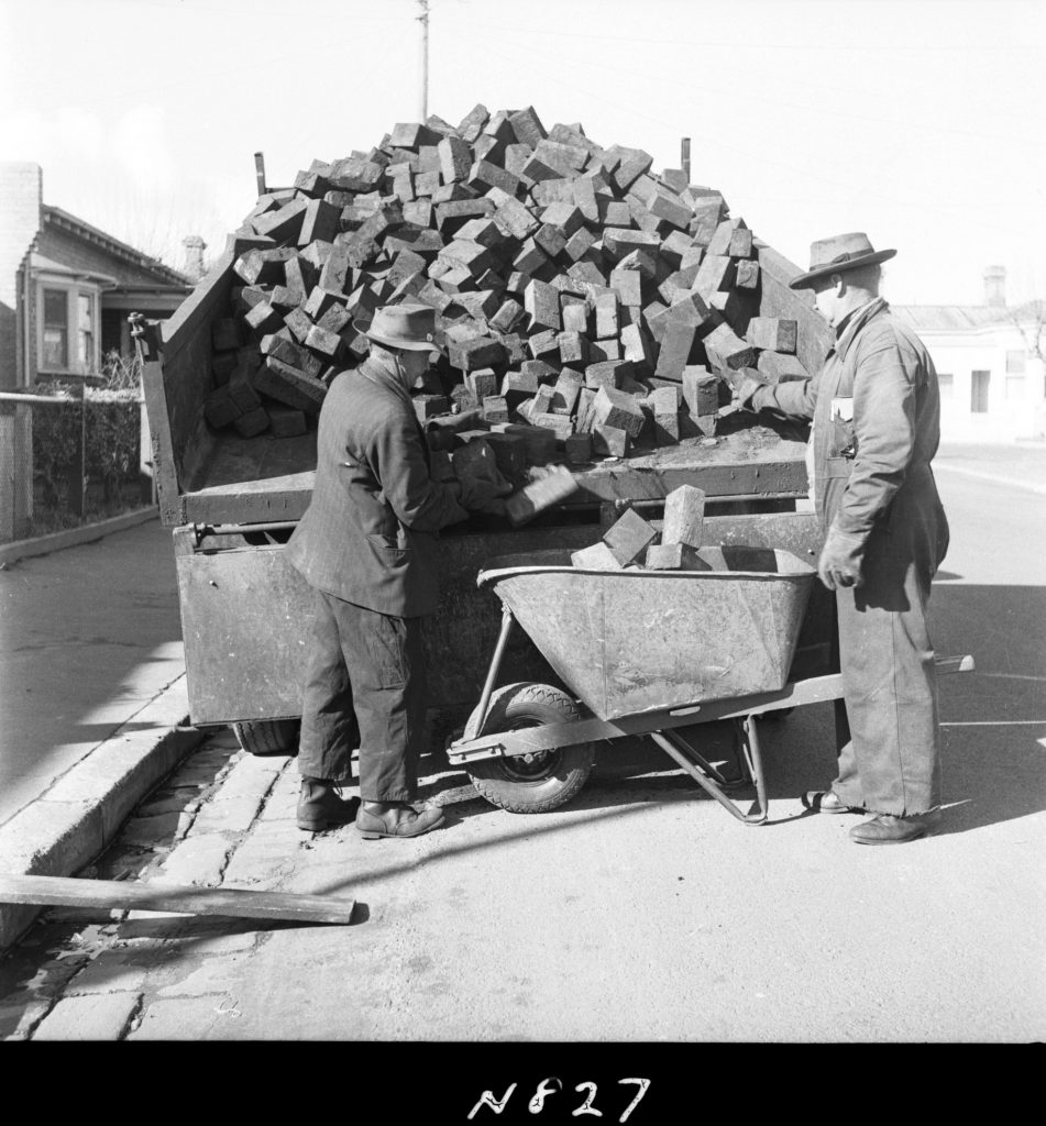 N827 Image showing woodblocks being distributed to pensioners for firewood