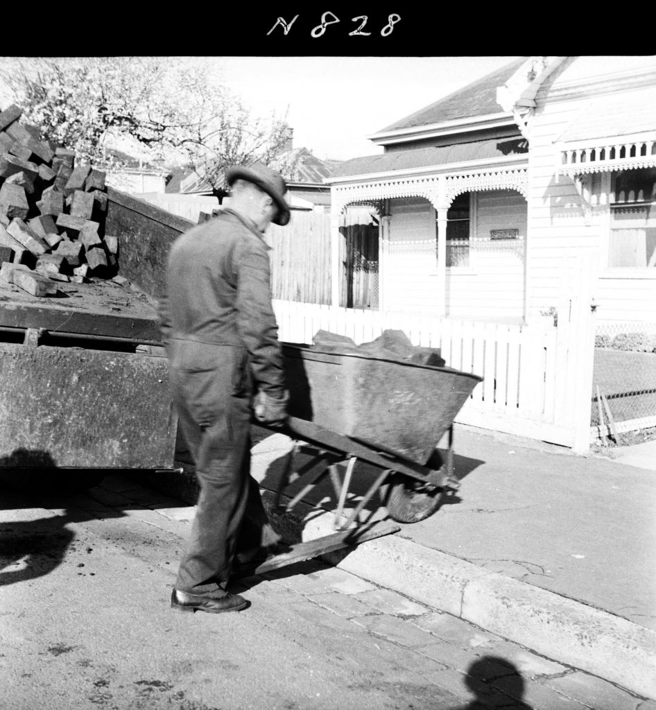 N828 Image showing woodblocks being distributed to pensioners for firewood