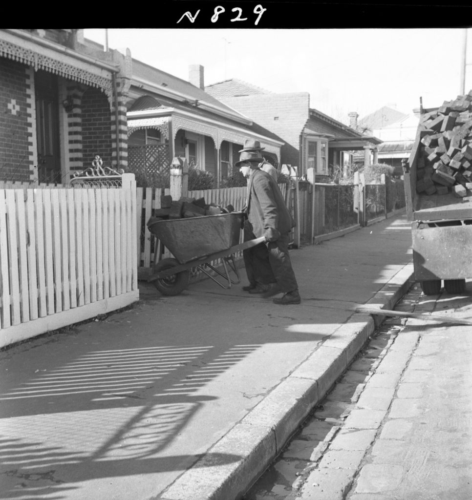 N829 Image showing woodblocks being distributed to pensioners for firewood