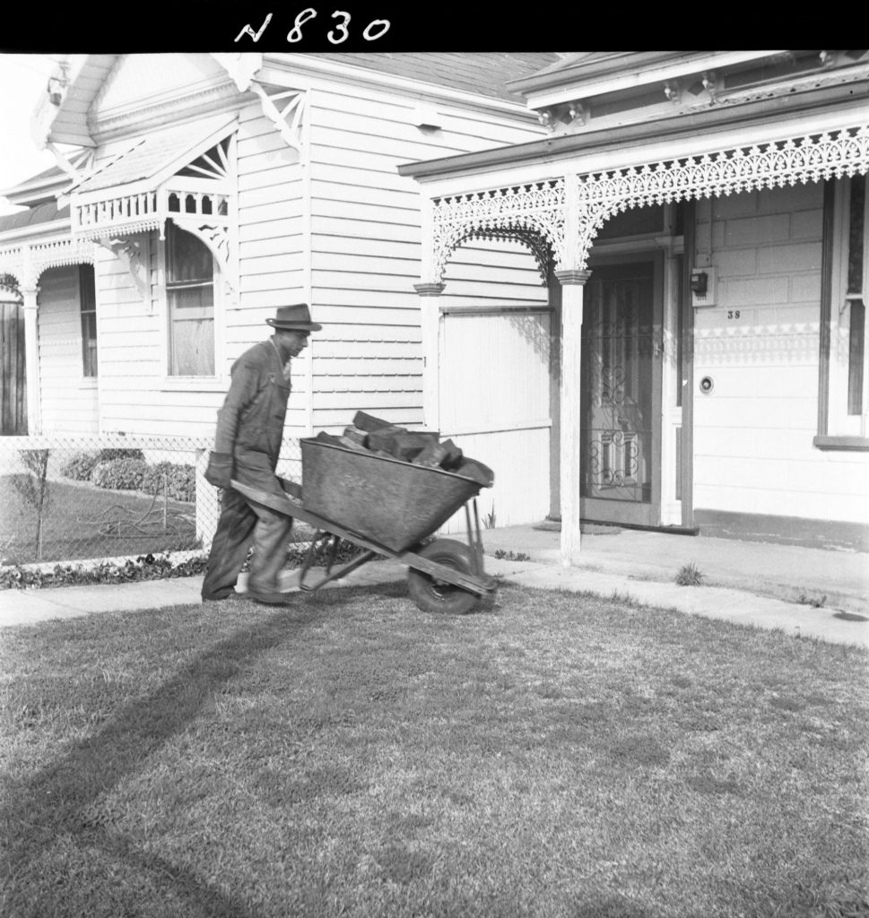 N830 Image showing woodblocks being distributed to pensioners for firewood