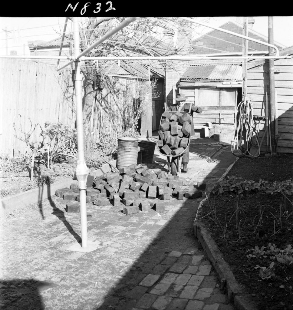 N832 Image showing woodblocks being distributed to pensioners for firewood