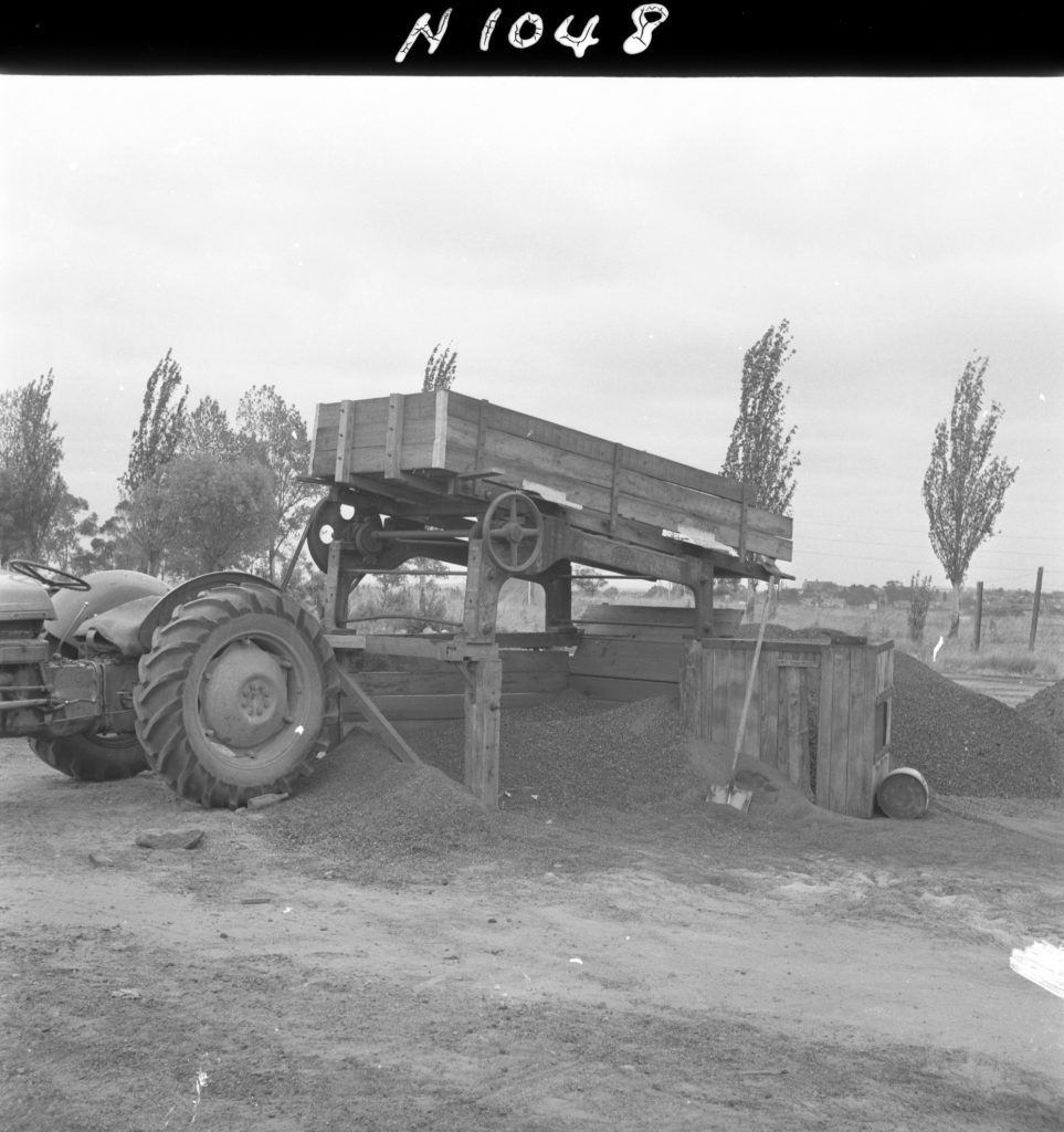 N1048 Image showing screening cinders for the Womens Athletic Ground in Royal Park