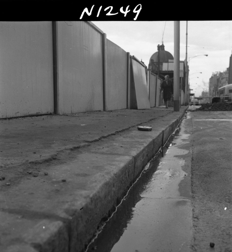 N1249 Image showing a Flinders Street footpath cracked and raised above the kerb