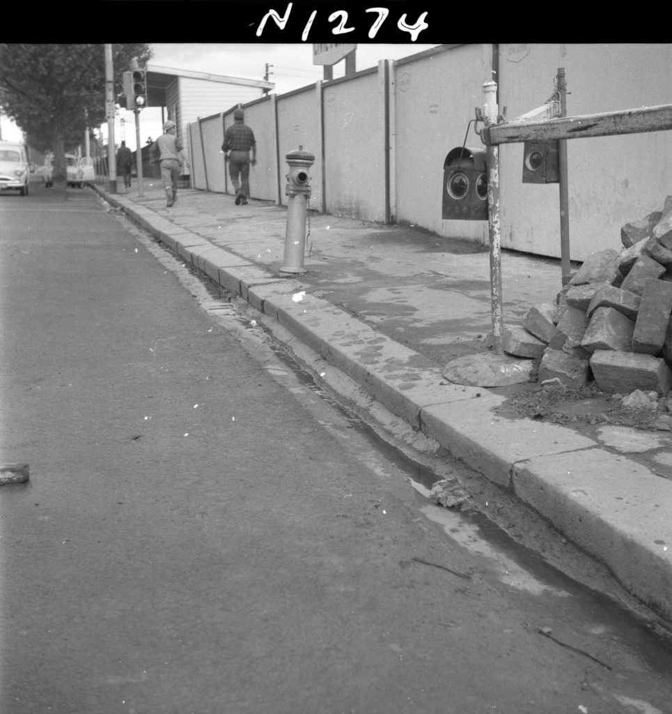 N1274 Image of the south side of Flinders Street, showing kerb damage, channel and path