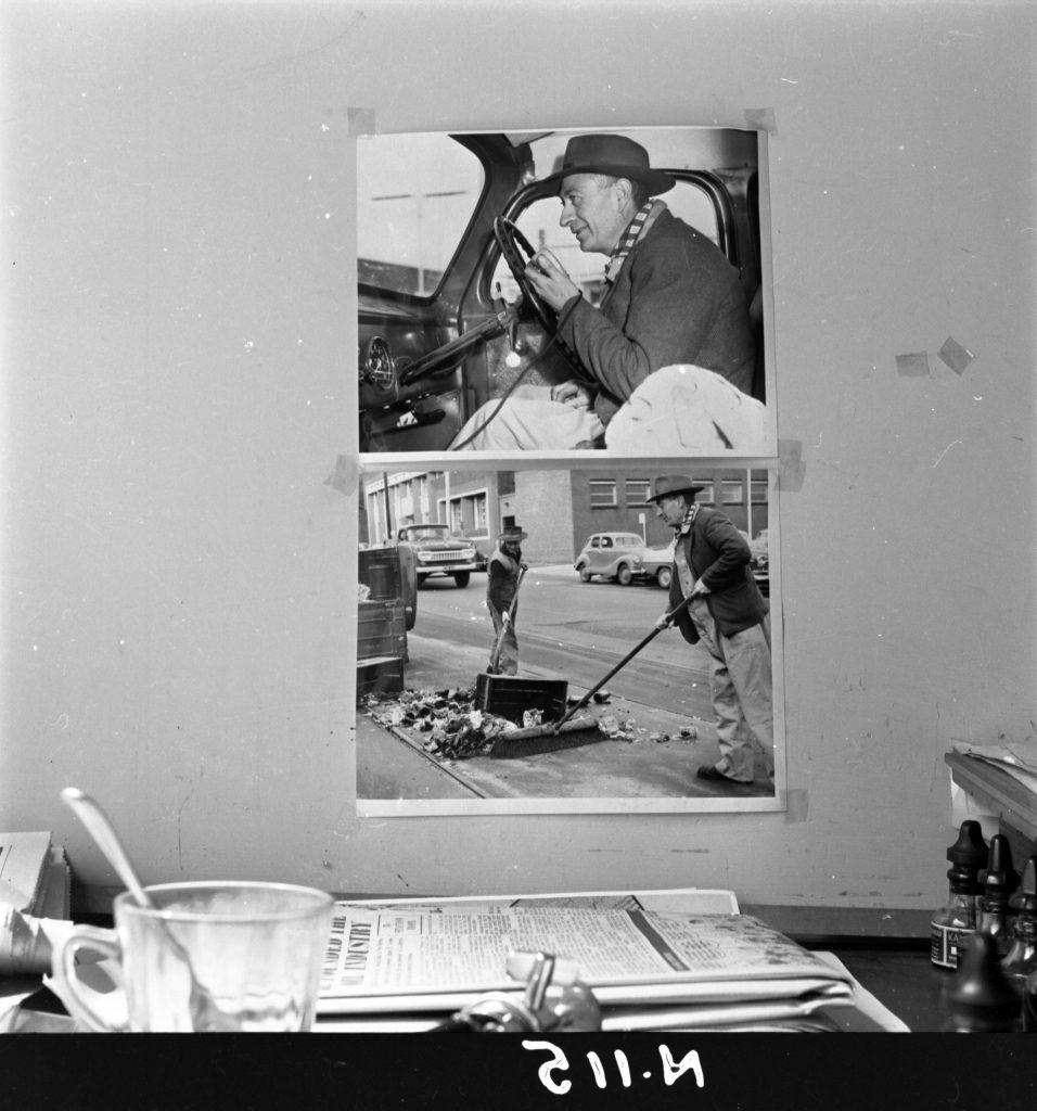 N115 Image showing two photos hanging above a desk – of a radio call, and an emergency street clearing