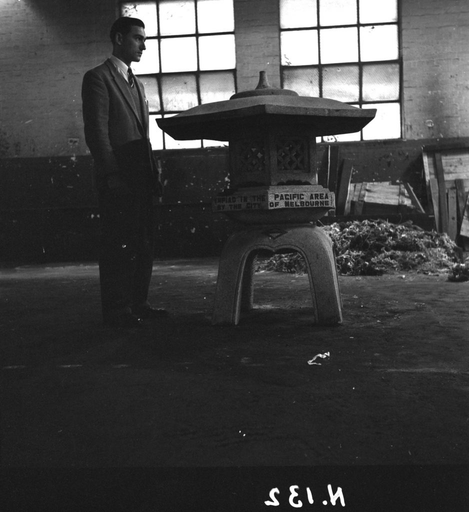 N132 Image showing a man standing next to a monument gifted from the city of Yokohana