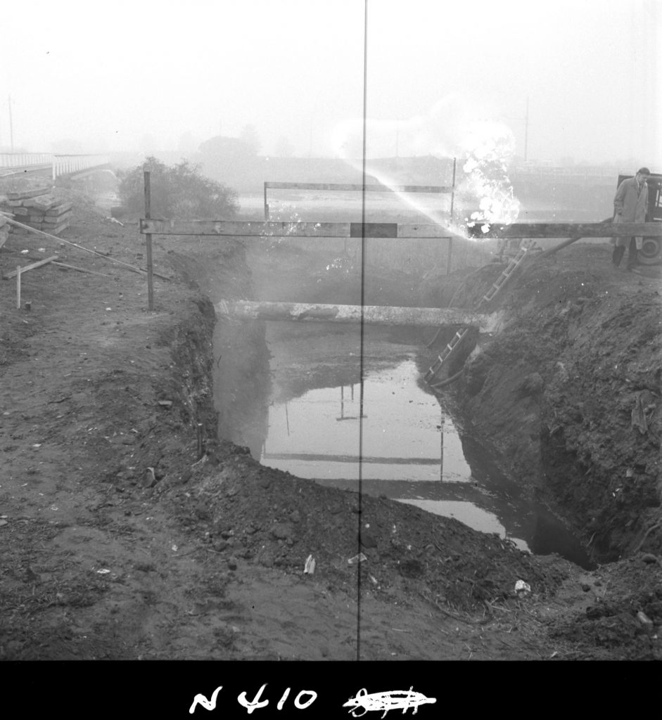 N410 Image showing installation of a drain under the railway, during construction of the Fish Market on Footscray Road