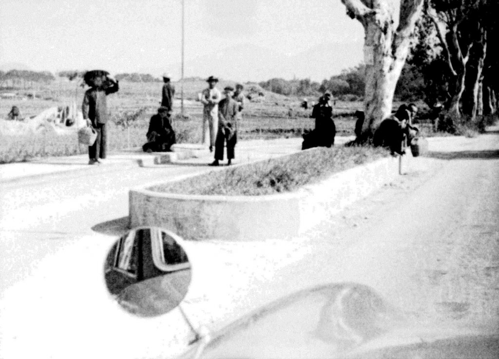 35A-28r Image showing people standing around a raised traffic island in rural Hong Kong