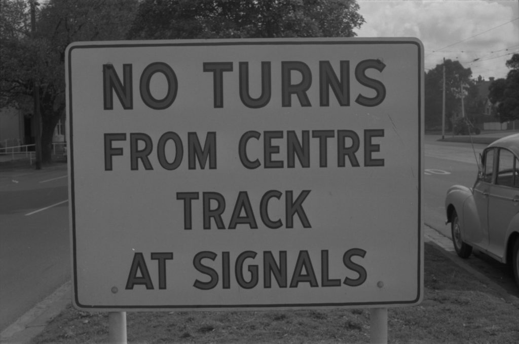 35A-35c Image of a sign marked “No turns from centre track at signals”