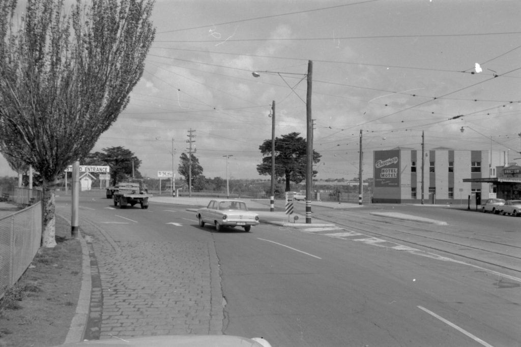 35A-52b Image of a roundabout near Flemington Racecourse, showing tram tracks and a “keep left” sign