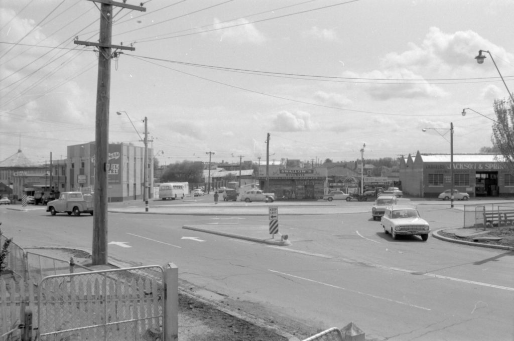 35A-52c Image of a roundabout near Flemington Racecourse, showing tram tracks and a “keep left” sign