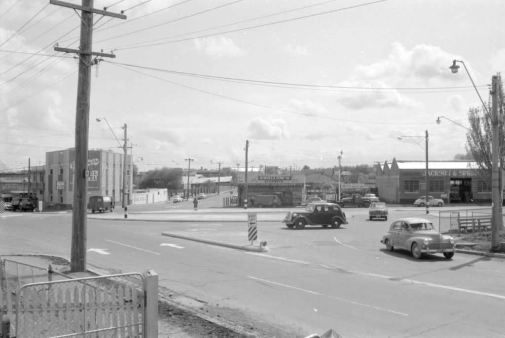 35A-52d Image of a roundabout near Flemington Racecourse, showing tram tracks and a “keep left” sign