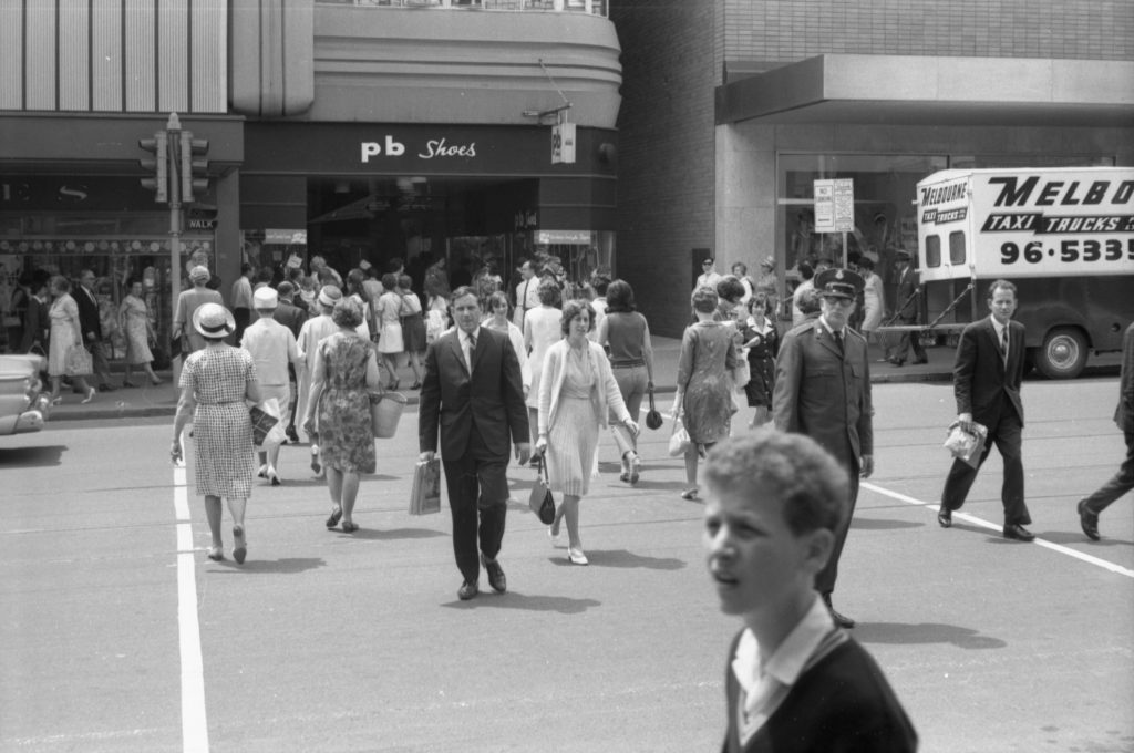 35A-54b Image showing pedestrians crossing a road, with “walk” light visible