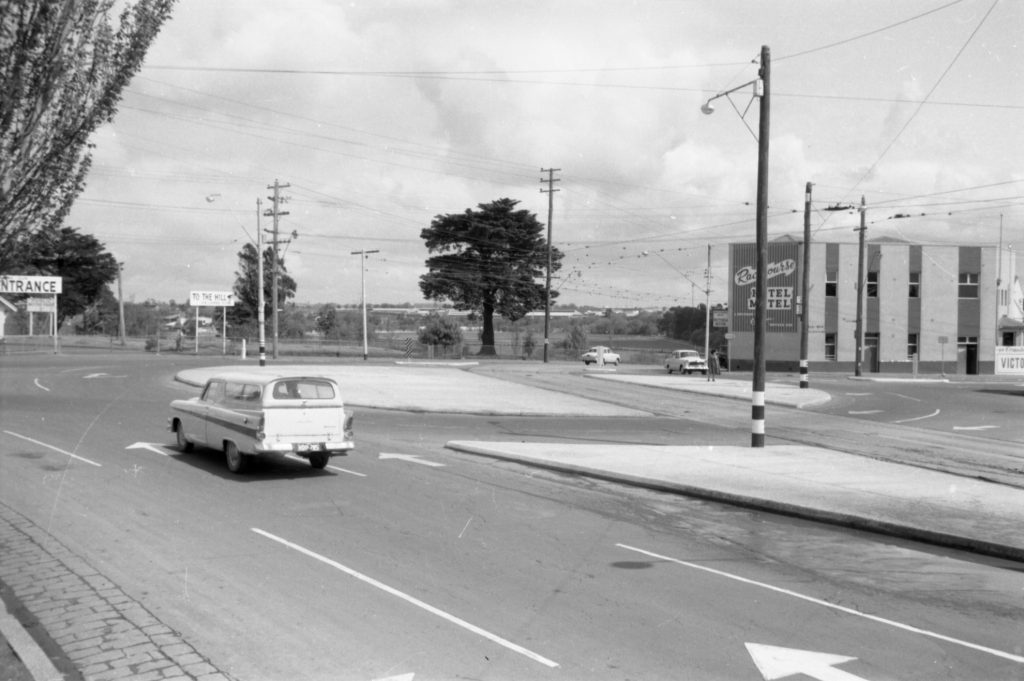 35A-77a Image of a roundabout near Flemington Racecourse, showing tram tracks and a “keep left” sign