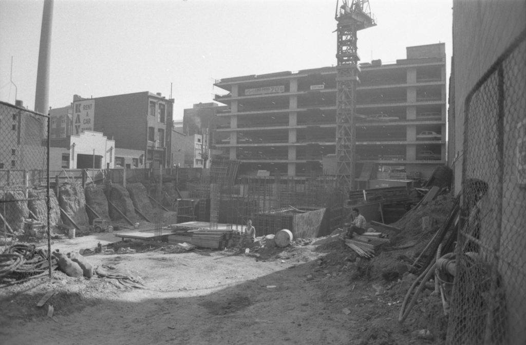 35B-65d Image of a construction area, with car park visible behind