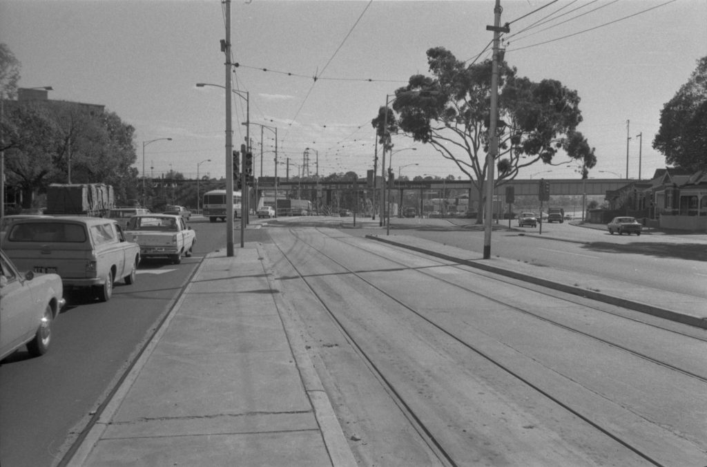 35B-67c Image looking north-west up Flemington Road, showing traffic and tram tracks