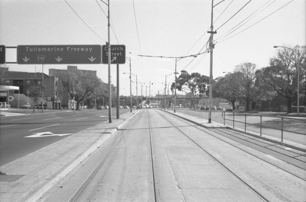 35B-67d Image looking north-west up Flemington Road, showing traffic and tram tracks