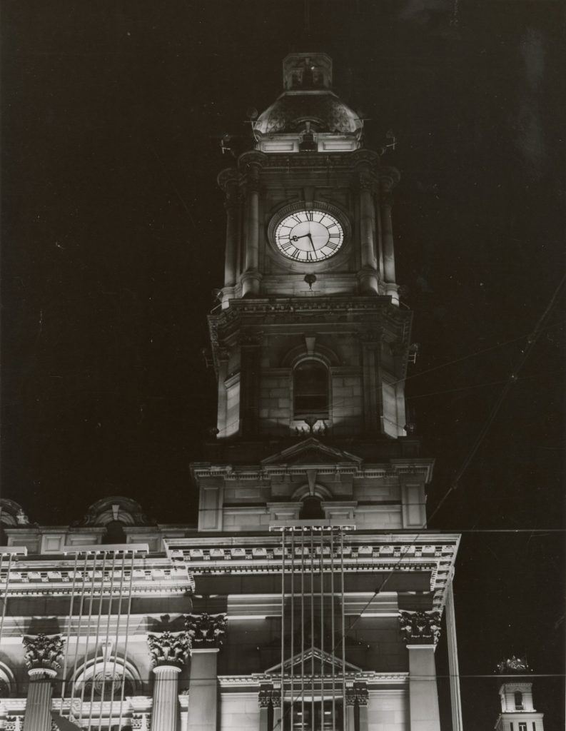Image of the clocktower of Melbourne Town Hall illuminated at night